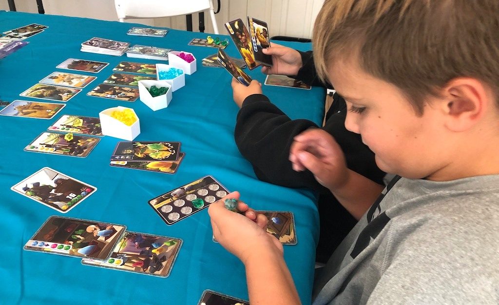 Boys playing Century: Golem Edition